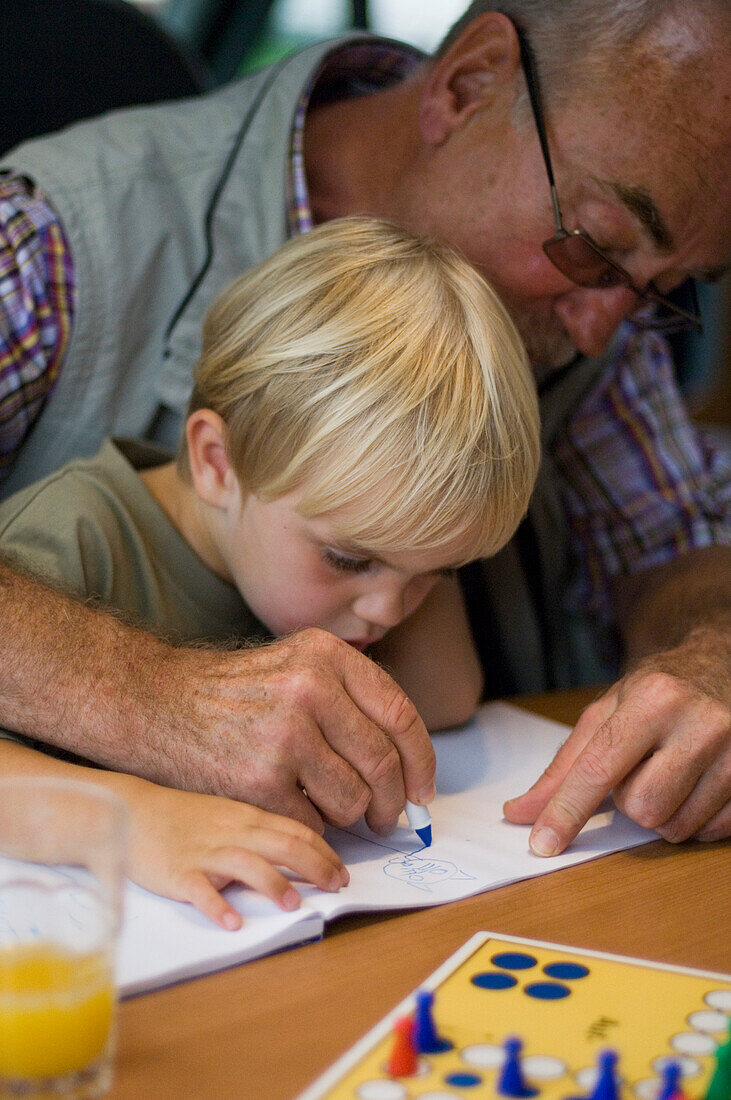 Grandfather, Granddad, drawing a picture with grandson,Holiday,  Bavaria, Germany