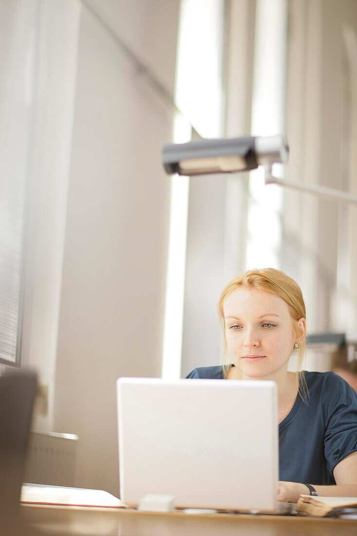 Female student working in the library, University. Education