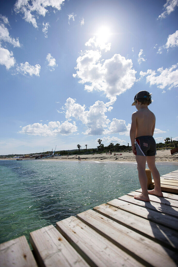 Boy on the jetty at Tahiti beach, St. Tropez, Cote d'Azur, Provence, France