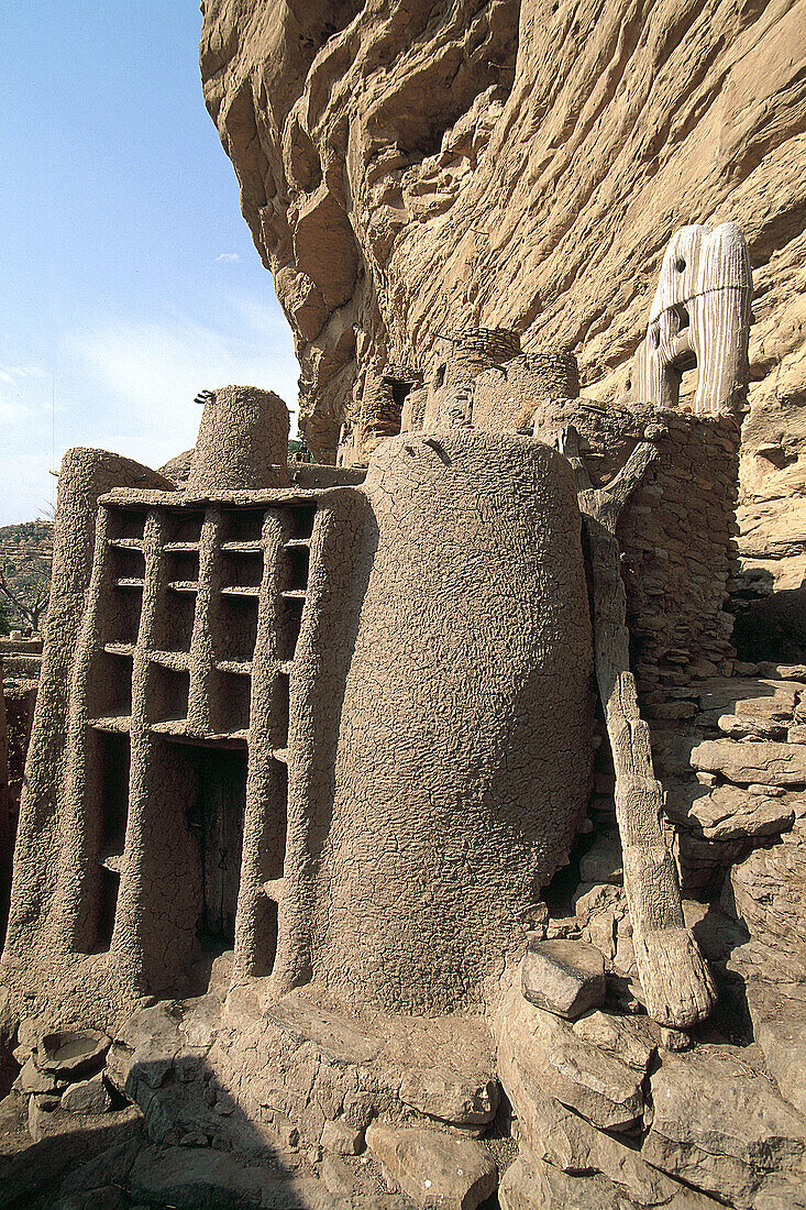 Bandiagara cliffs shelter several Dogon villages to protect them from agressions. Architecture of sharp roof huts and granaries is very characteristic. Bandiagara cliffs. Dogon Country. Mali.