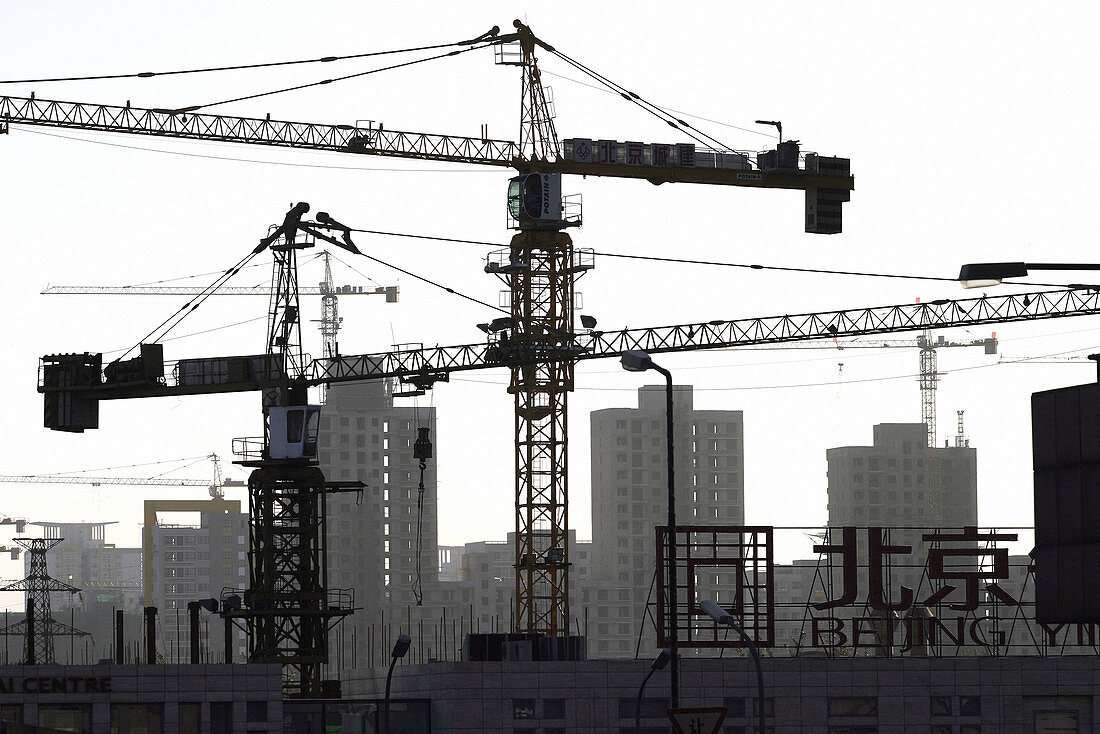 A construction field with newly built high-rised apartment buildings in the background, Beijing, China