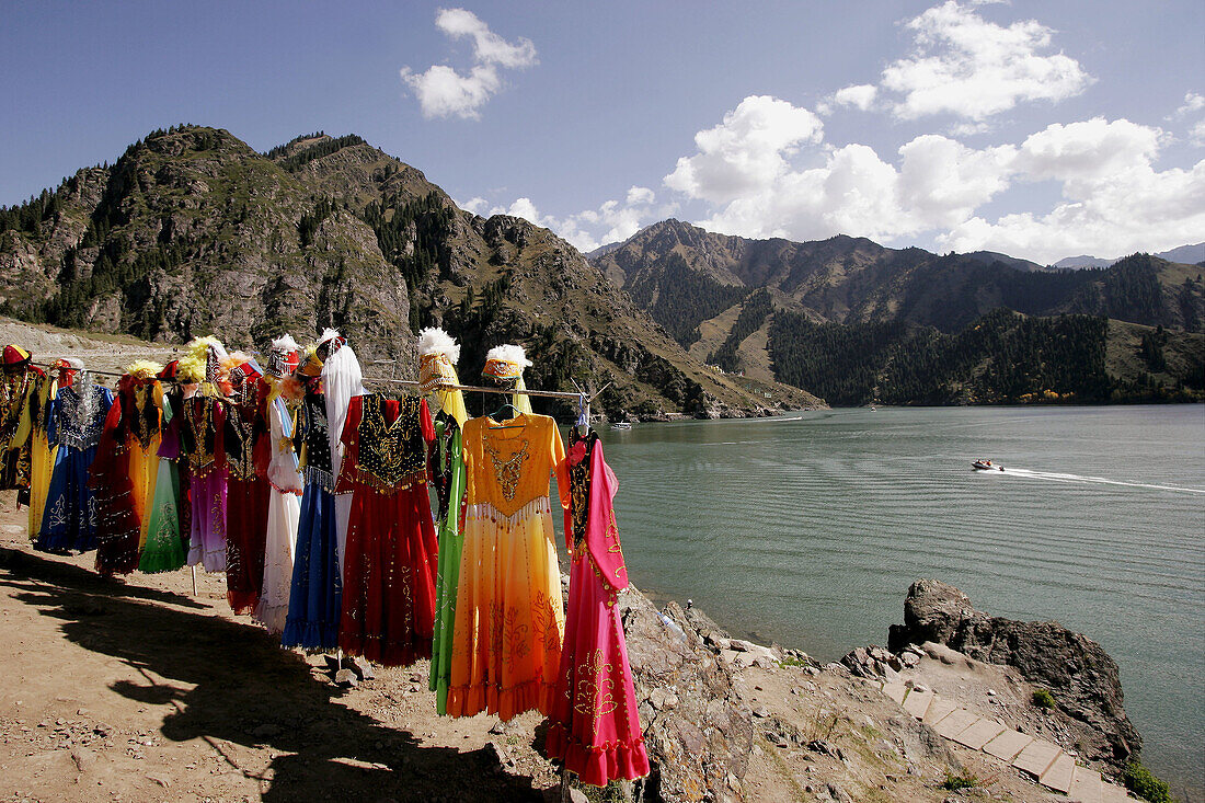 Uighur woman’s dress for hire for souvenir photo shoots on the shore of Tian Chi Lake (Heavenly Lake), Urumchi, Xinjiang Province, China
