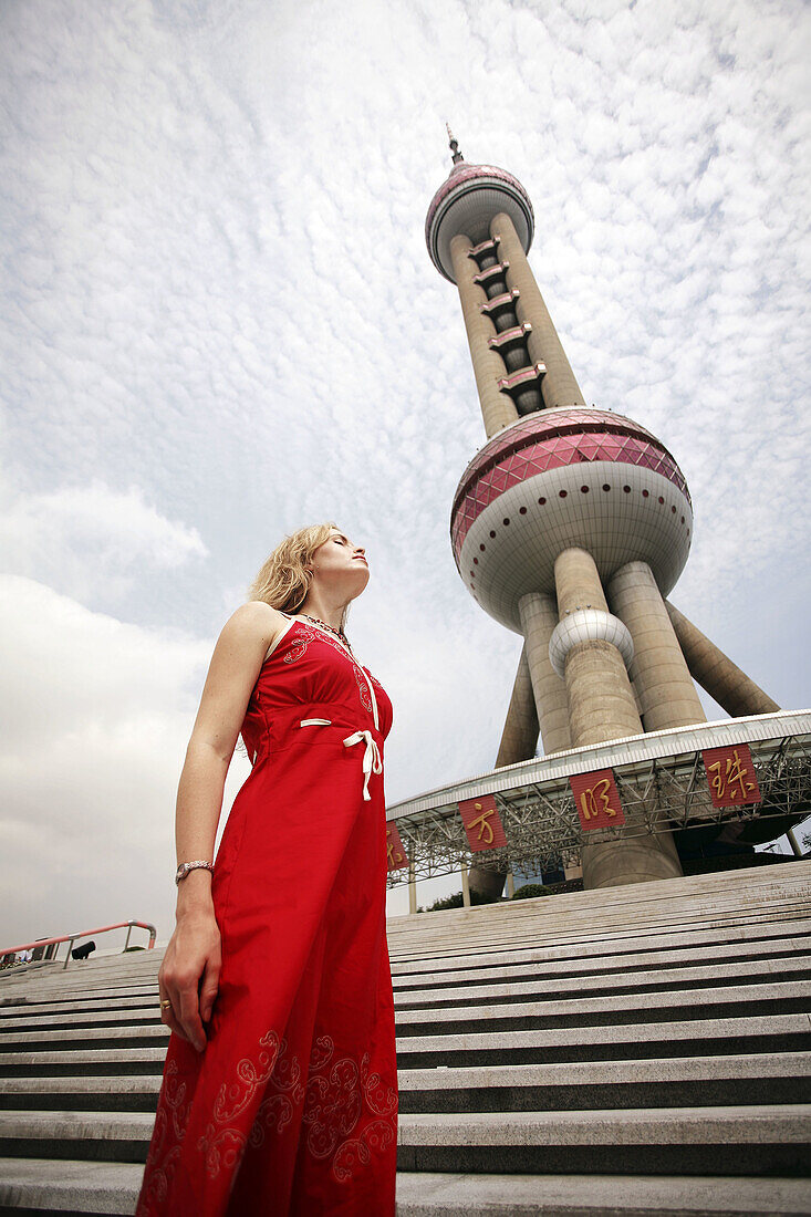Woman next to TV tower. Shanghai city, the Pearl of Orient. China.