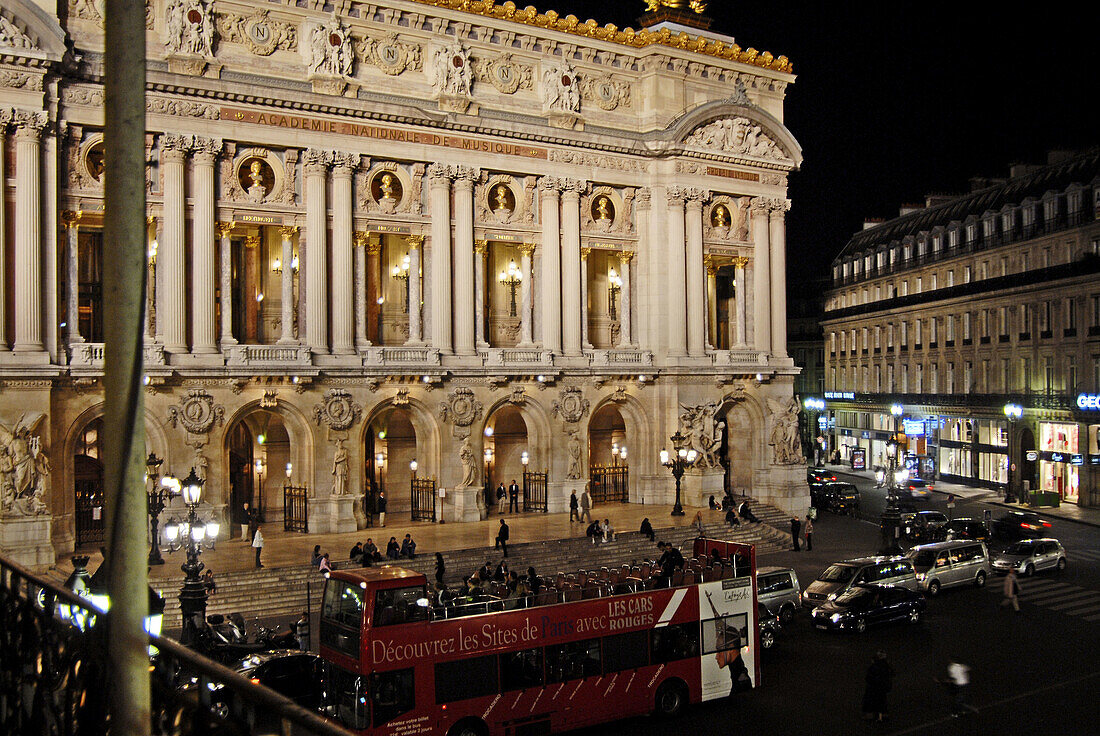 Night time view of Paris, France, Opera House, aglow in lights, and the sourrounding area.