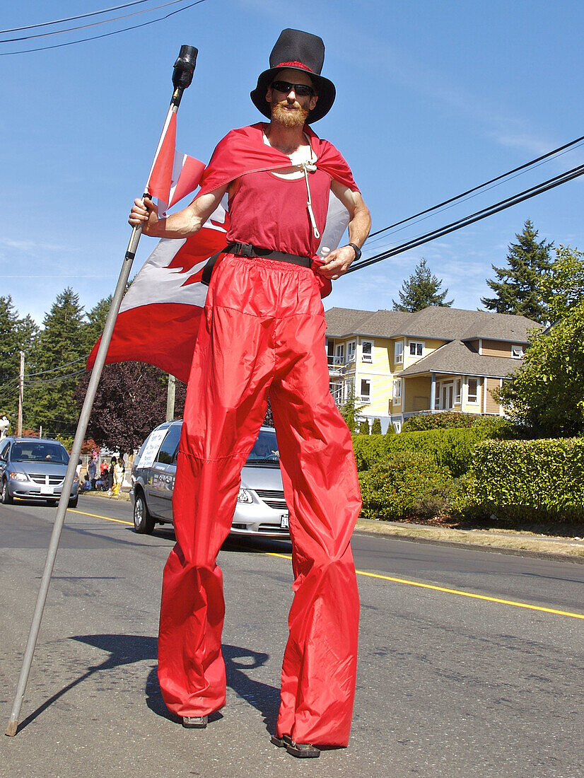 Comox Nautical Days Parade. A man in costume walking on stilts. BC, Canada