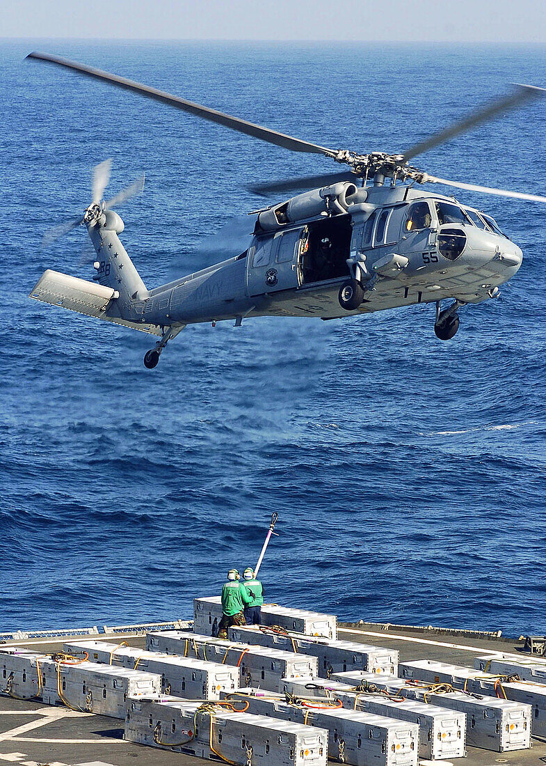 Military Sealift Command (MSC) ammunition ships USNS Shasta (T-AE 33) and MH-60S Seahawk helicopter