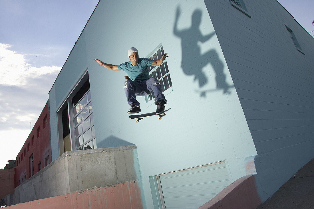 Skater skateboarding behind a building in downtown Kansas City, Missouri, USA