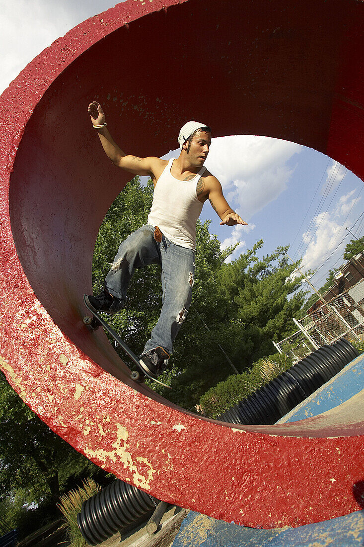Skater skateboarding in red tube at a skate park in Kansas City, Missouri, USA
