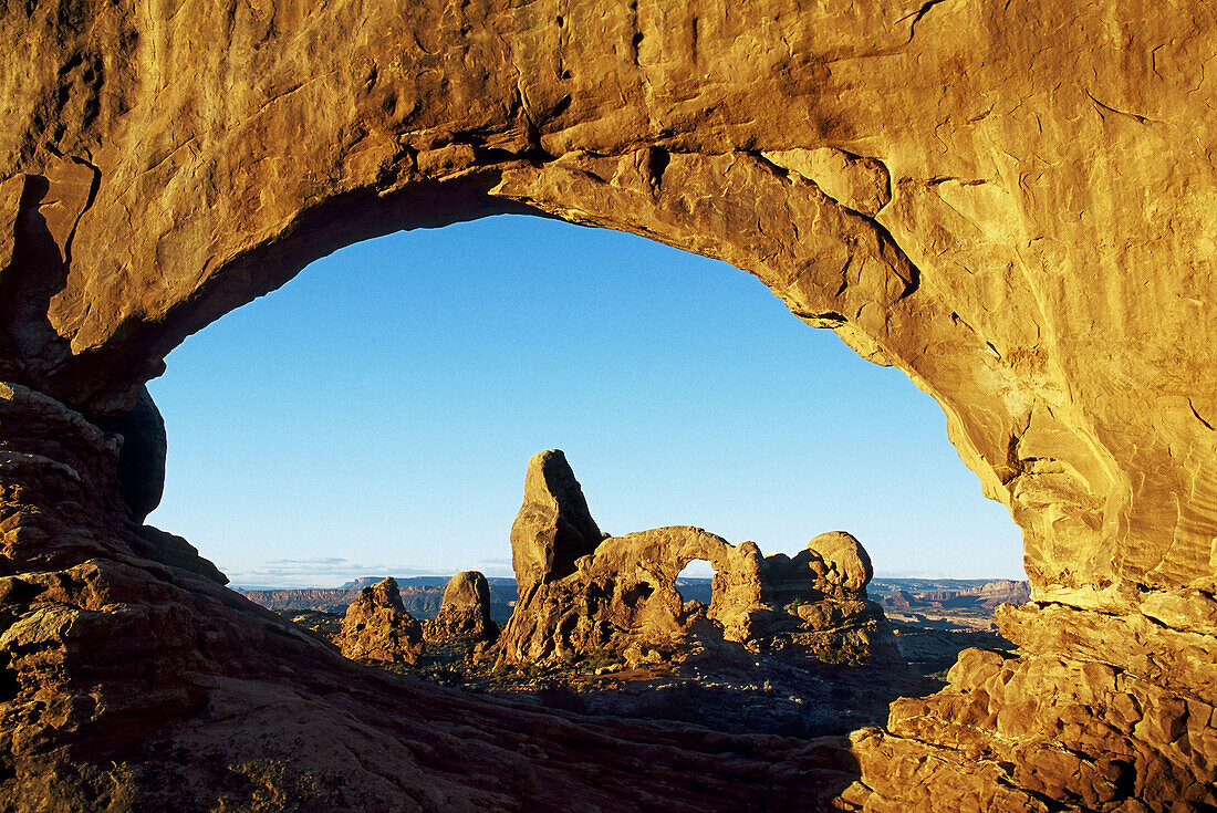 North Window frames Turret Arch at sunrise, Arches National Park, Utah, USA.