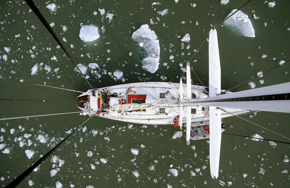 View down from top of mast to deck of sailing boat passing iceberg, Kings Bay, Svalbard, Spitzbergen, Norway