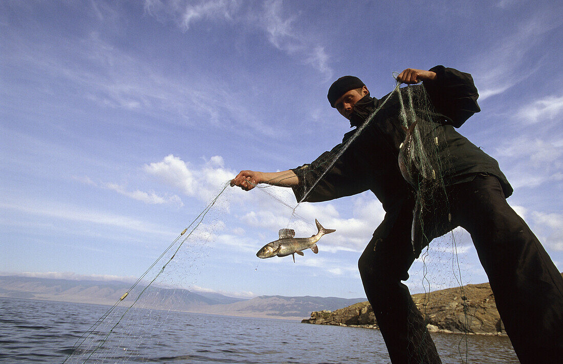 Man fishing on Baikal Lake in spring, Siberia, Russia