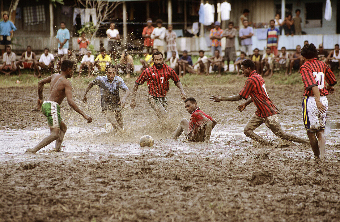 Asmat men playing football in Atsj village, Western Papuasia, Former Irian-Jaya, Indonesia