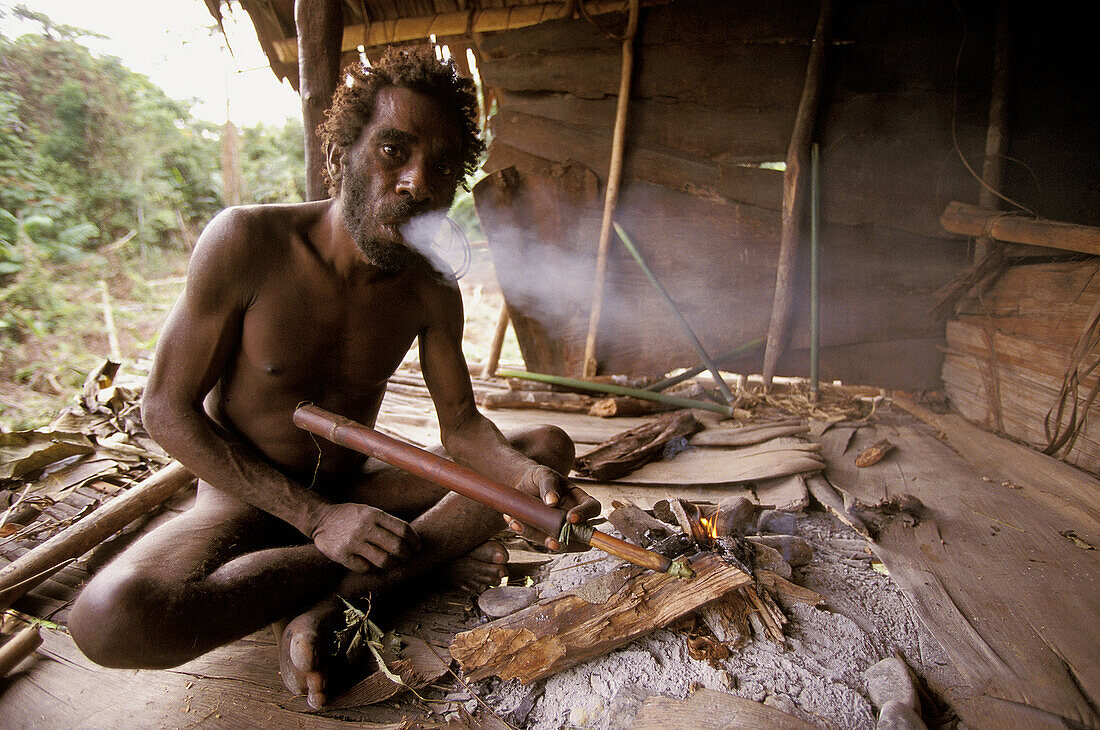 Portrait of a Koroway man smoking, Western Papuasia, former Irian-jaya, Indonesia