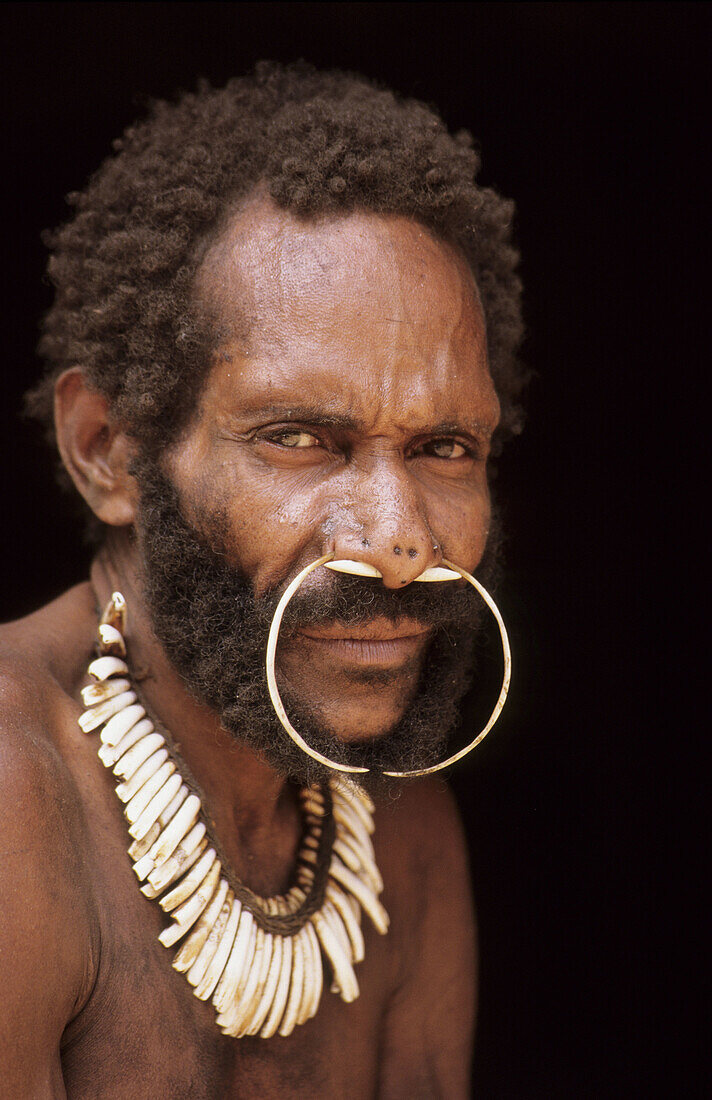 Portrait of a Koroway man wearing a nose adornment made of casoar bones, Western Papuasia, former Irian-jaya, Indonesia