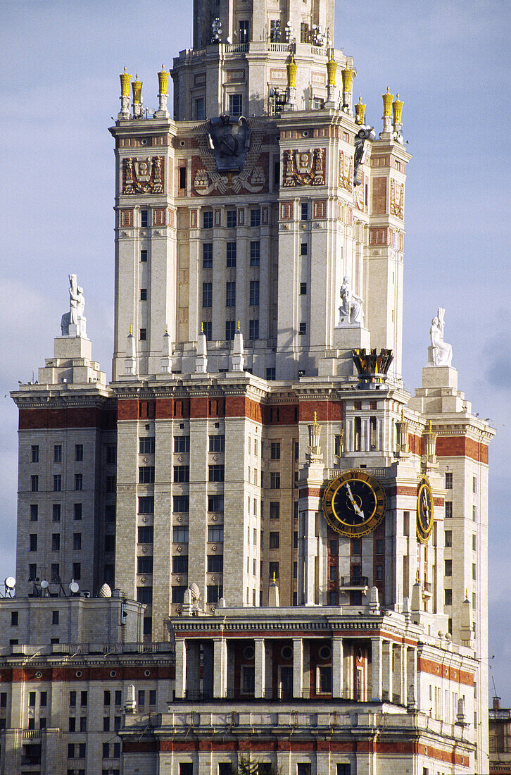 Building of Moscow state university with clock and statues, Russia.