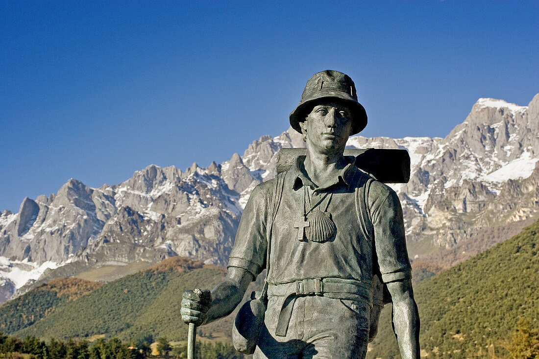 Monument to the pilgrim in Potes with Picos de Europa in background. Cantabria, Spain