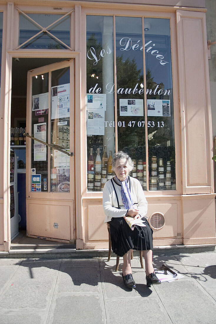 Woman in front of an old business in Paris. France.