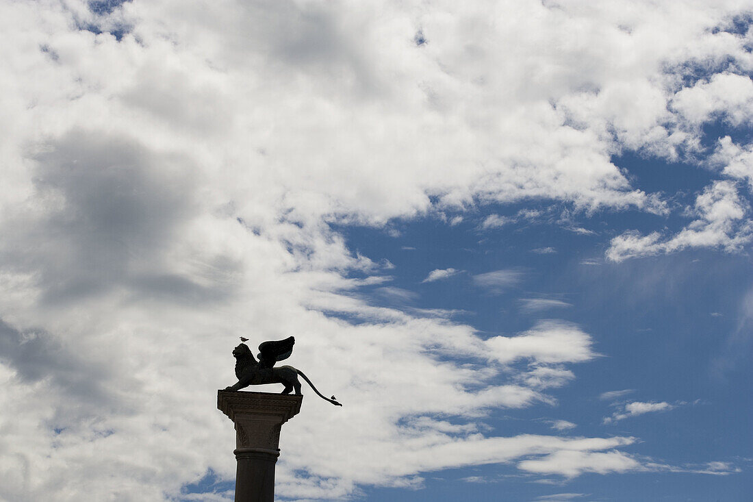 Winged lion of Venice on a pillar in St. Marks Square, Venice. Veneto, Italy