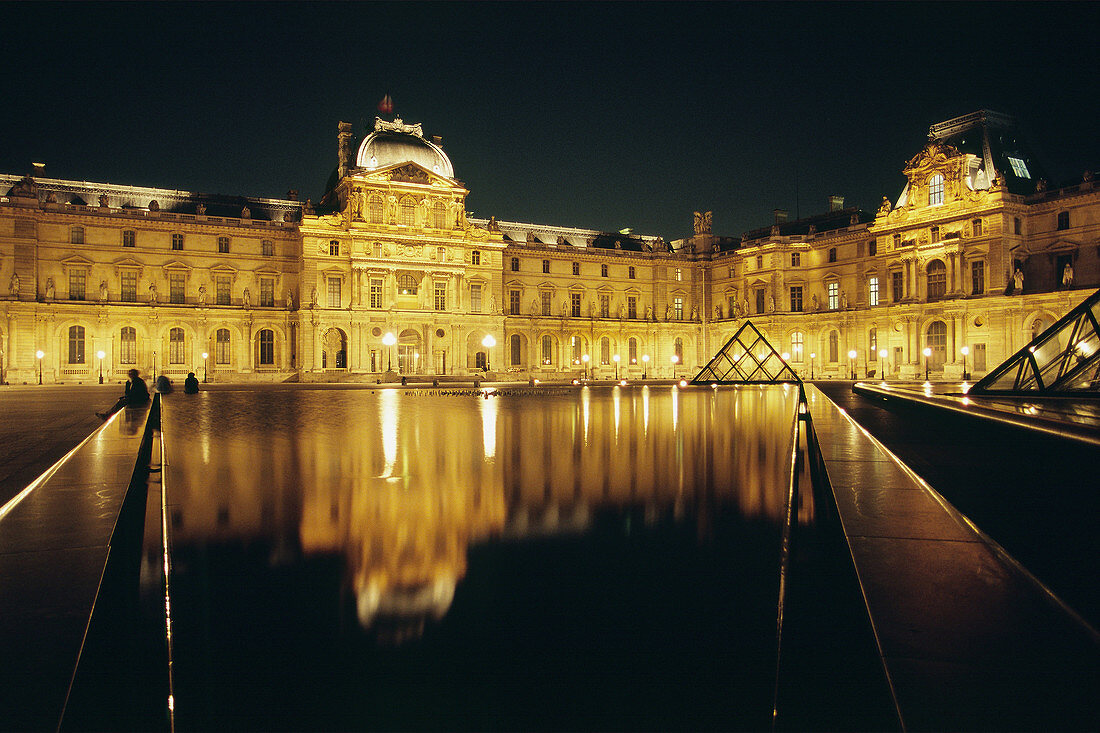 Grand Louvre art museum and Cour Napoleon by night, Paris. France