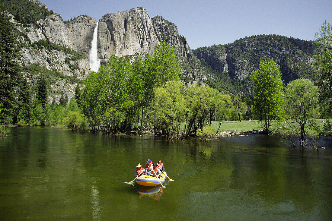 Rafting along the Merced River with the Upper Yosemite Falls in background, Yosemite National Park. California, USA