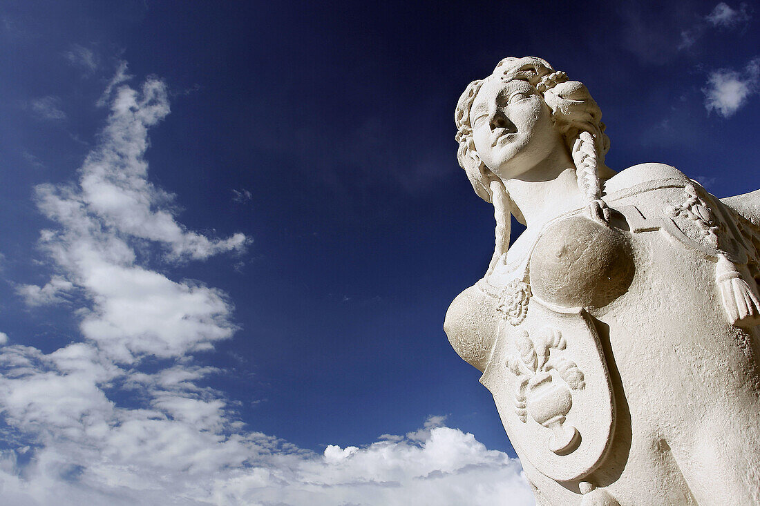 A sphinx statue with lion body and human heads adorning the gardens in the Belvedere complex in Wieden, Vienna, Austria.