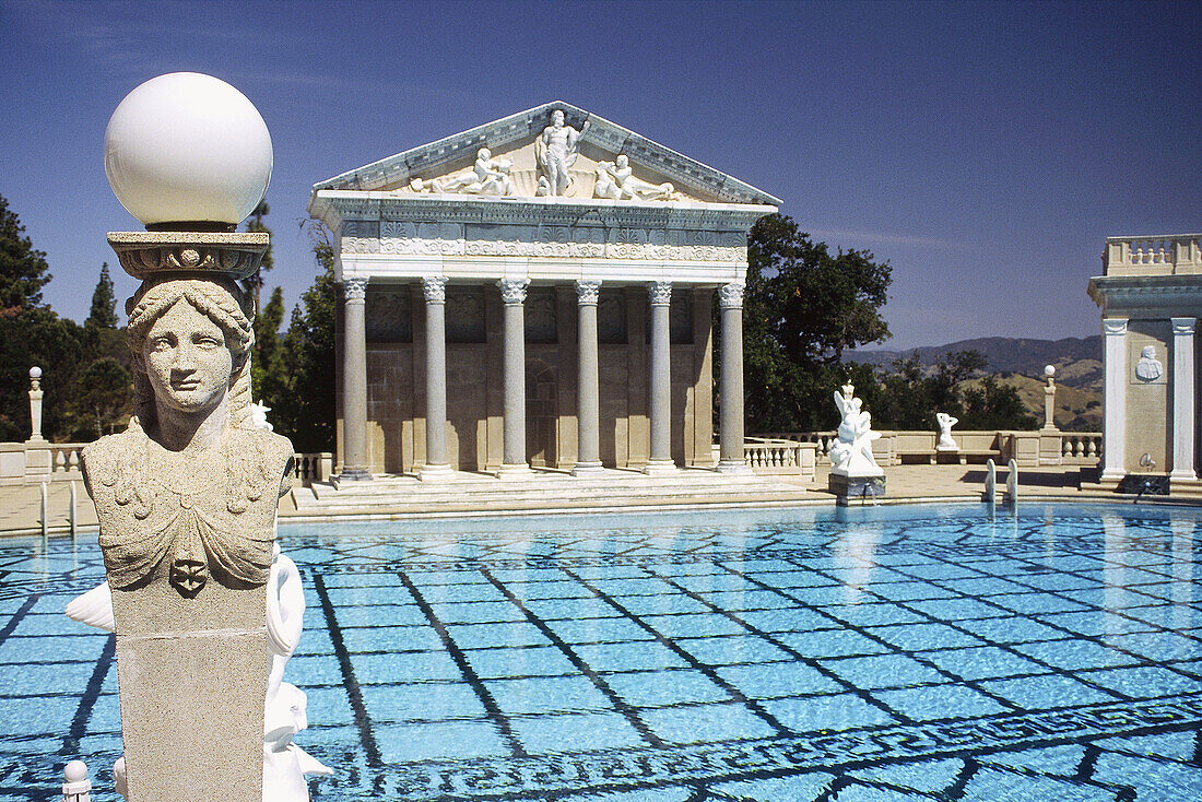 The Neptune Pool flanked by colonnades and the facade of a Greek temple in the grounds of Hearst Castle, San Simeon, California, United States of America.