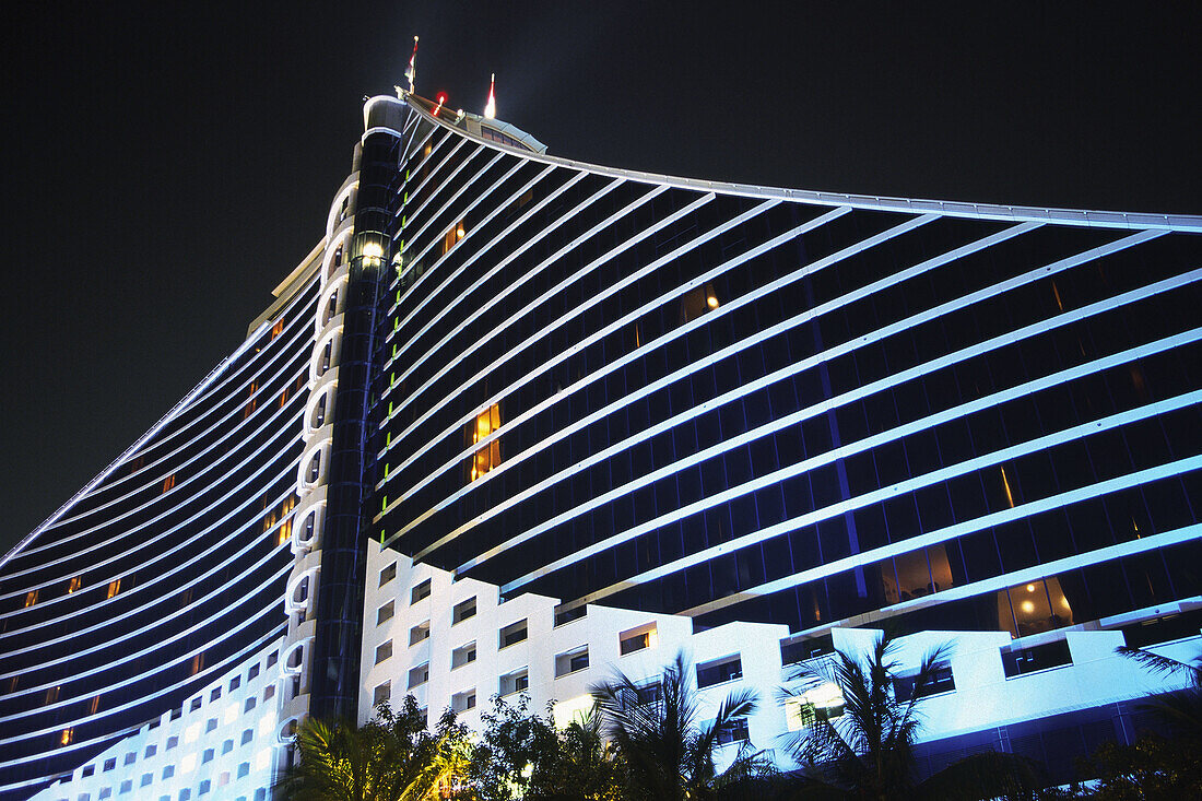 The Jumeirah Beach Resort 5 star luxury hotel by night at Jumeirah Beach, Dubai, United Arab Emirates.