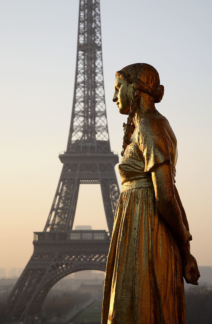 Golden statues of the Palais of Chaillot and the Eiffel Tower. Paris. France