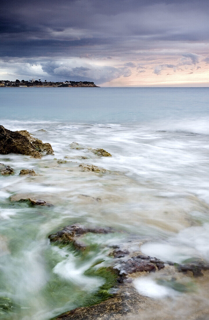 Sunrise. Campoamor beach, Cabo Roig at the back. Alicante province. Spain.