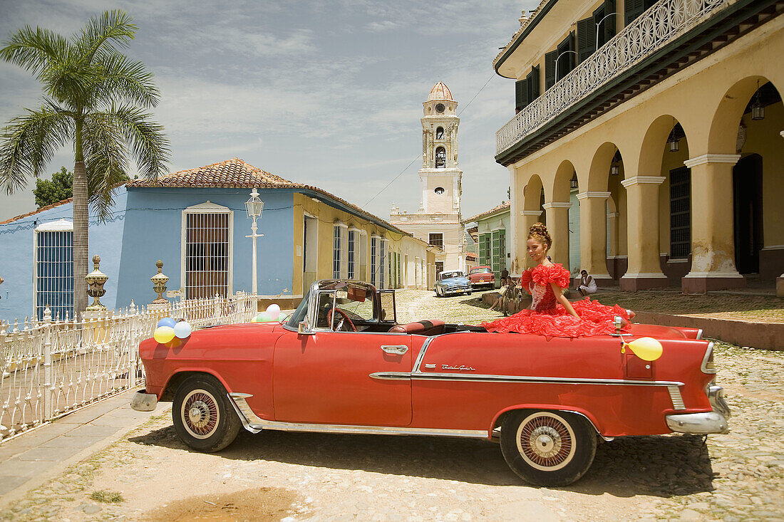 Girl celebrating her fifteenth birthday, called quinciñera. Plaza Mayor. Museum of the fight against bandits (Museo Nacional de la Lucha Contra Bandidos) in former convent of San Francisco de Asís, Trinidad. Sancti Spíritus province, Cuba