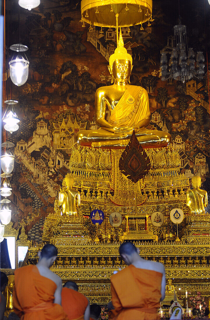 Monks praying in Wat Po, Bangkok, Thailand