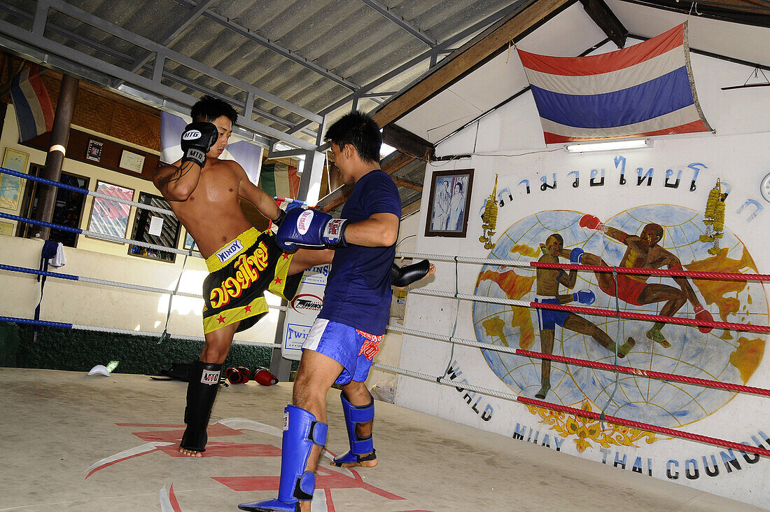 Two men Thai boxing in Khaosan district, Bangkok, Thailand