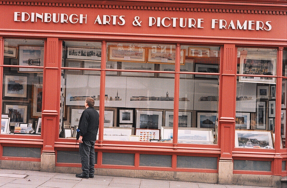 Man looking to an Art Gallery windos. Norton Street. Edinburgh. Scotland. UK.