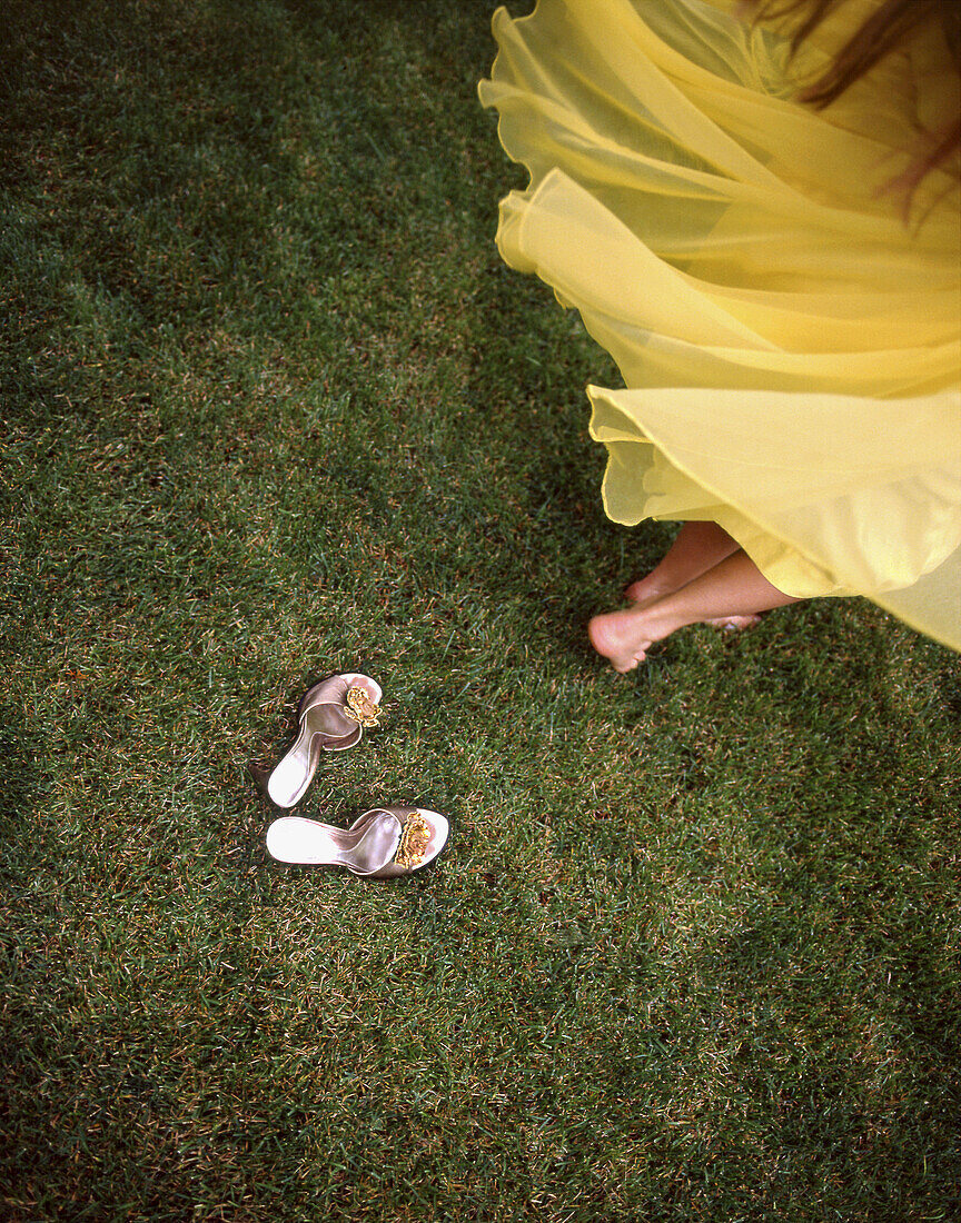 A woman spinning in a vintage yellow dress with her mothers vintage shoes left behind.