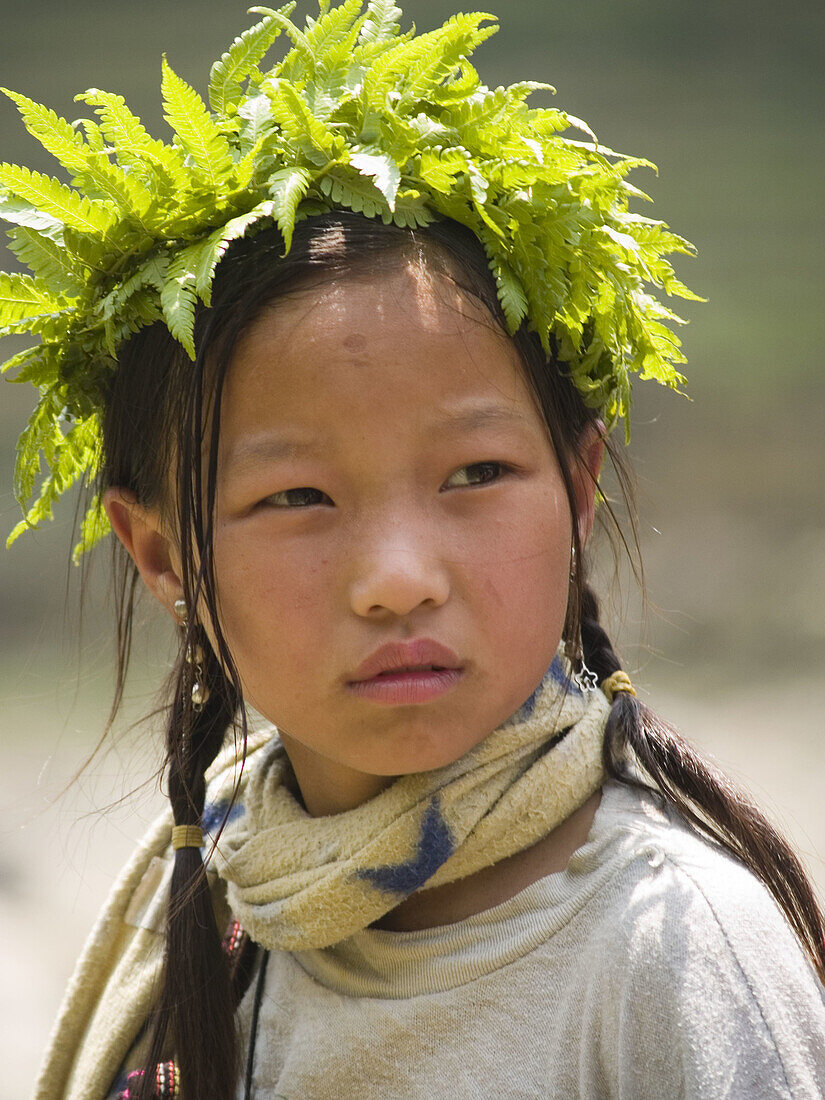 Young Hmong girl with a wreath sitting near the river. Lao Chai village, Sapa, Vietnam (april 2006)