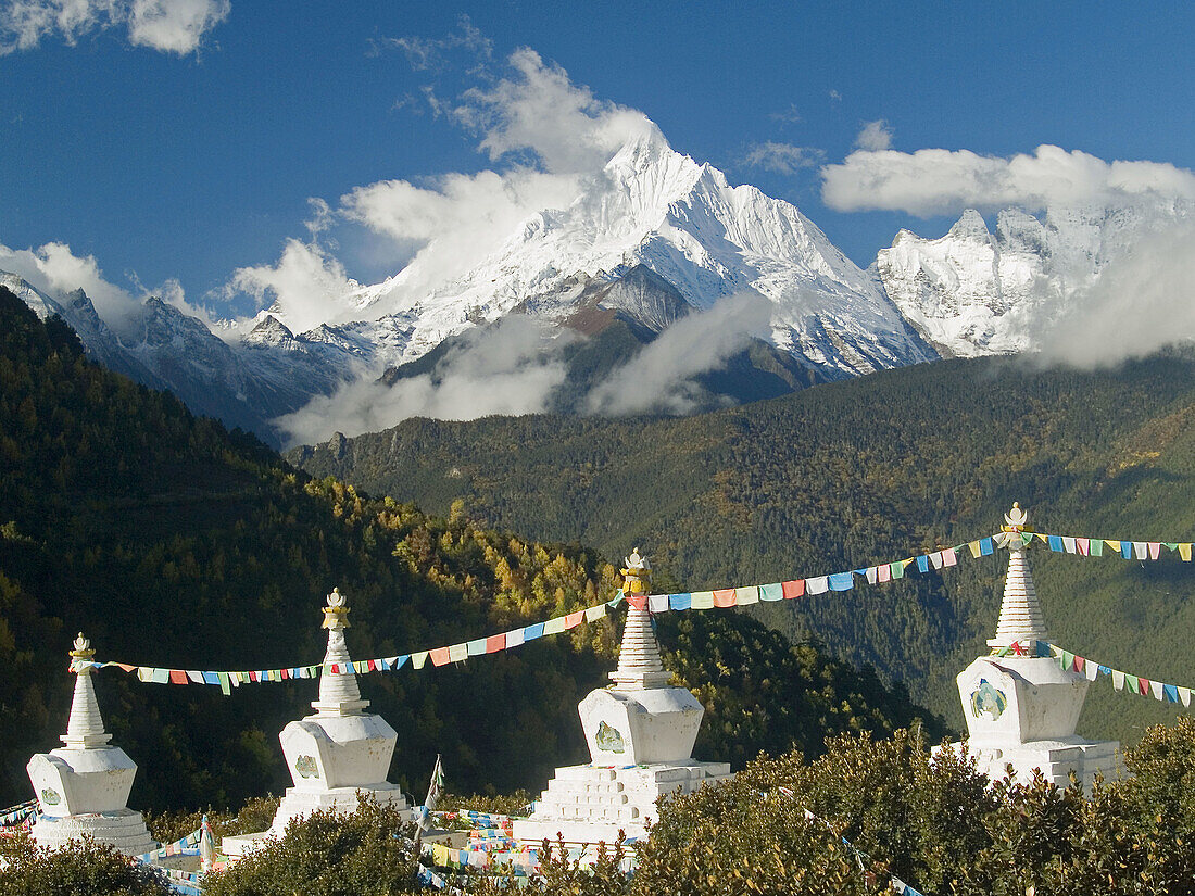 stupas fronting holy Tibetan peak Kawa Karpo, Meili Snow Mountains Natl. Park, China
