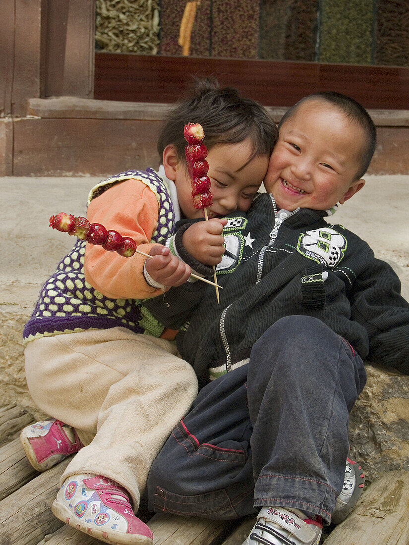 affectionate brother and sister hamming it up, Shangri La, China
