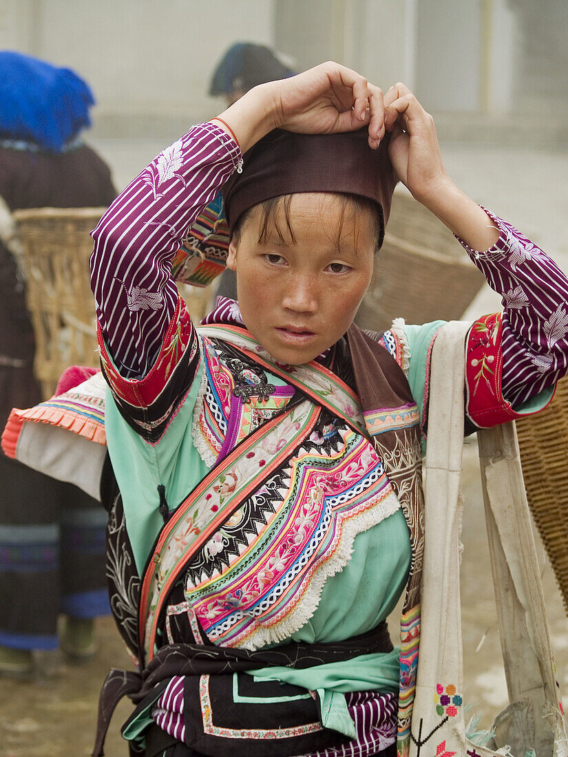 Yi gal carrying her market goods, Yuanyang, China