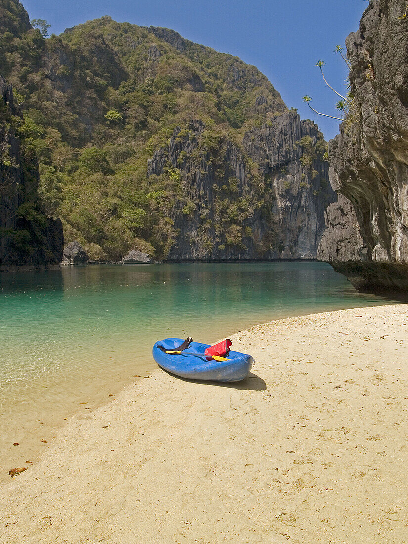 lone kayak in paradise, inside the Big Lagoon, Miniloc Island, Bacuit Archipelago, Palawan, Philippines