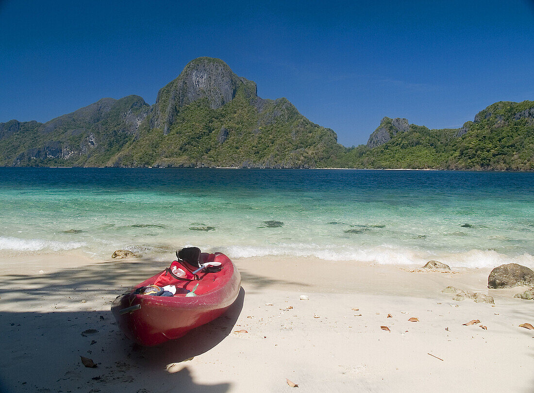 tropical delight, lone kayak on beach opposite Cadlao Island, Bacuit Archipelago, Palawan, Philippines