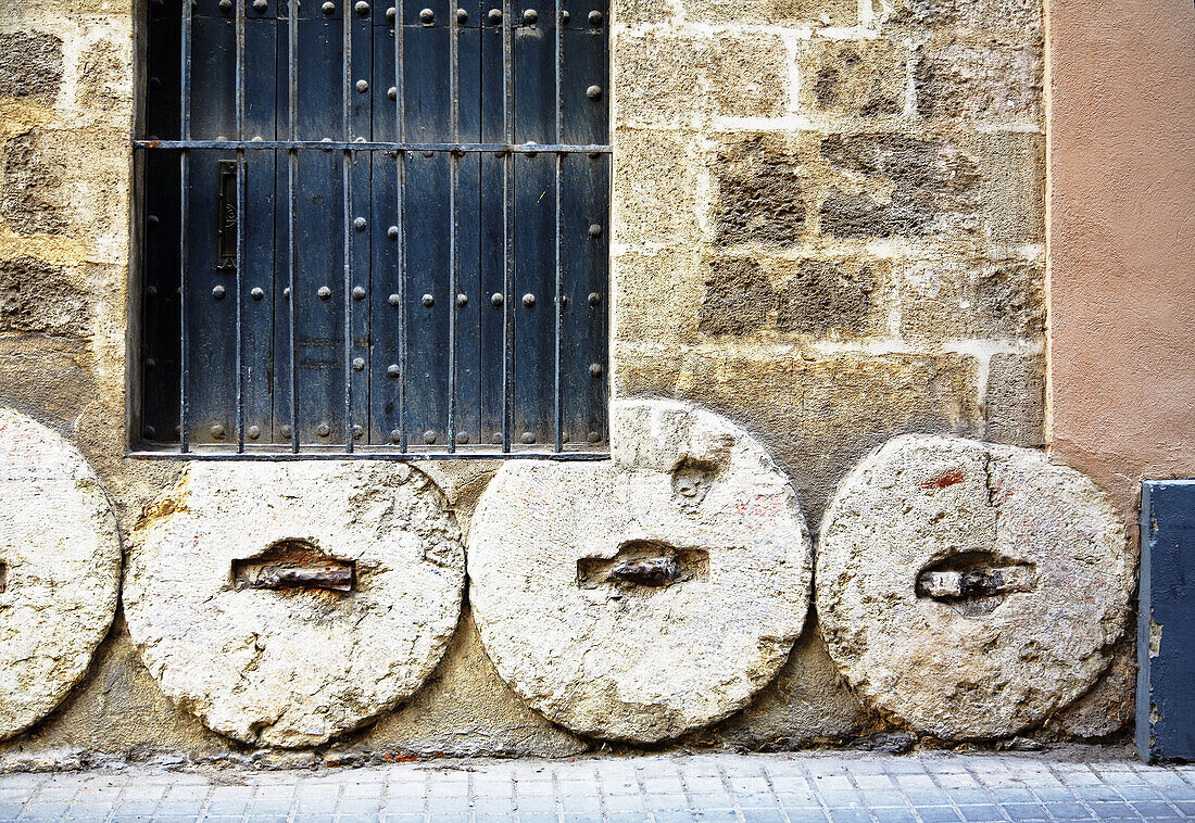 Old millstones. Santa Cruz quarter, Sevilla. Andalusia, Spain