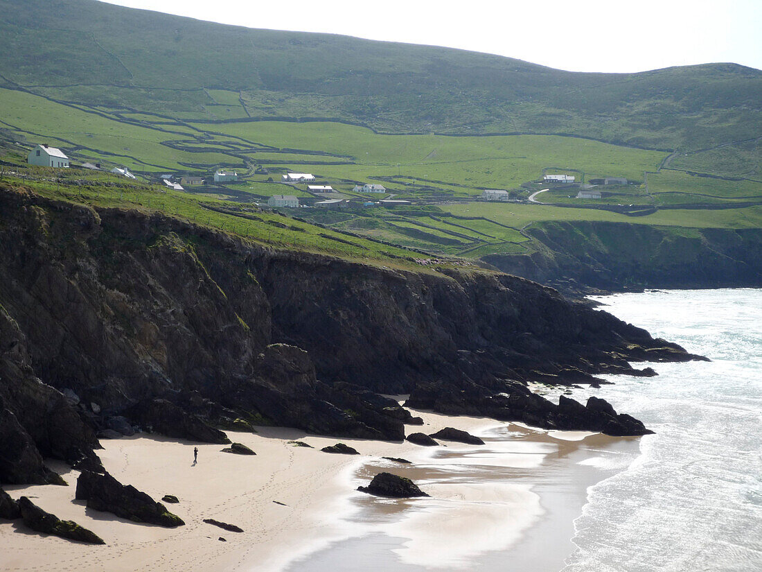Hiker walking the Dingle Way on Slea Head beach, Near Dunquin, Dingle Peninsula, County Kerry, Ireland