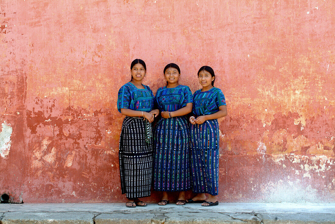 Three Maya women in traditional colours, Antigua, Guatemale, Central America