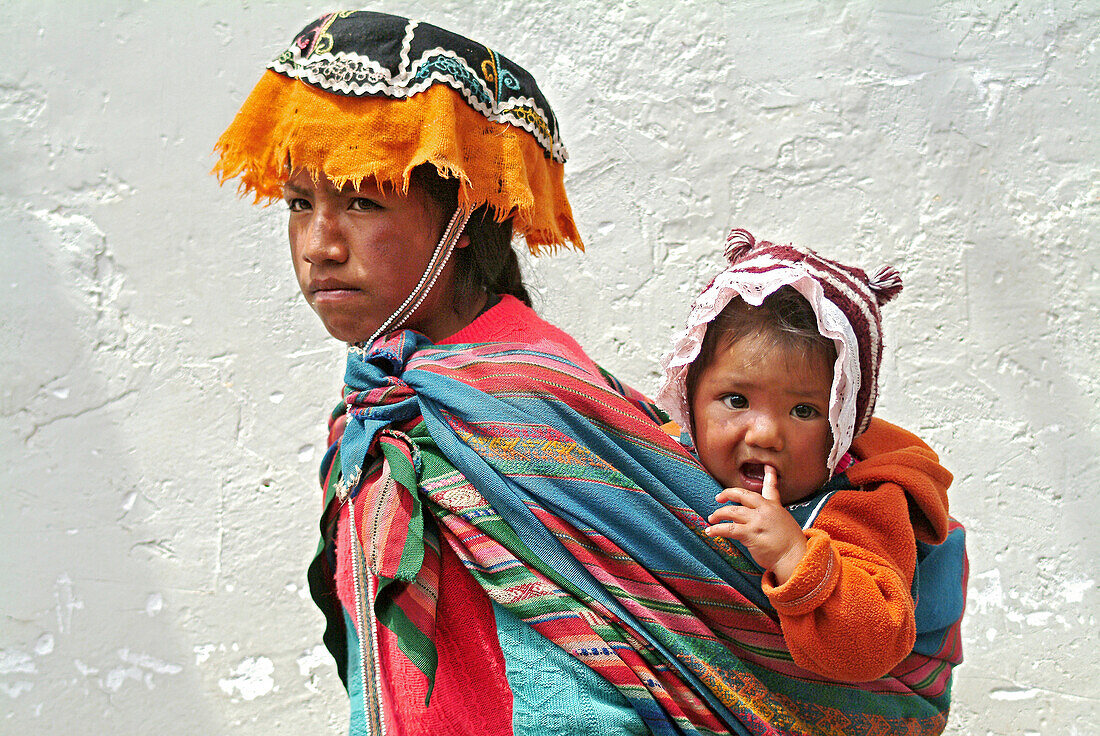 Young inca woman with baby in baby sling, Pisac, Peru, South America