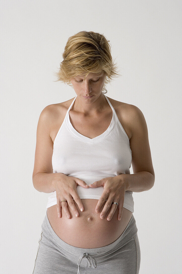Pregnant woman looking at her belly