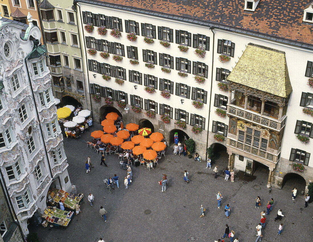 The Golden Roof -right- late Gothic oriel constructed for Emperor Maximilian I to serve as a royal box where he could sit in luxury and enjoy tournaments in the square below (c. 1500) and Helblinghaus -left-, old town, Innsbruck. Austria