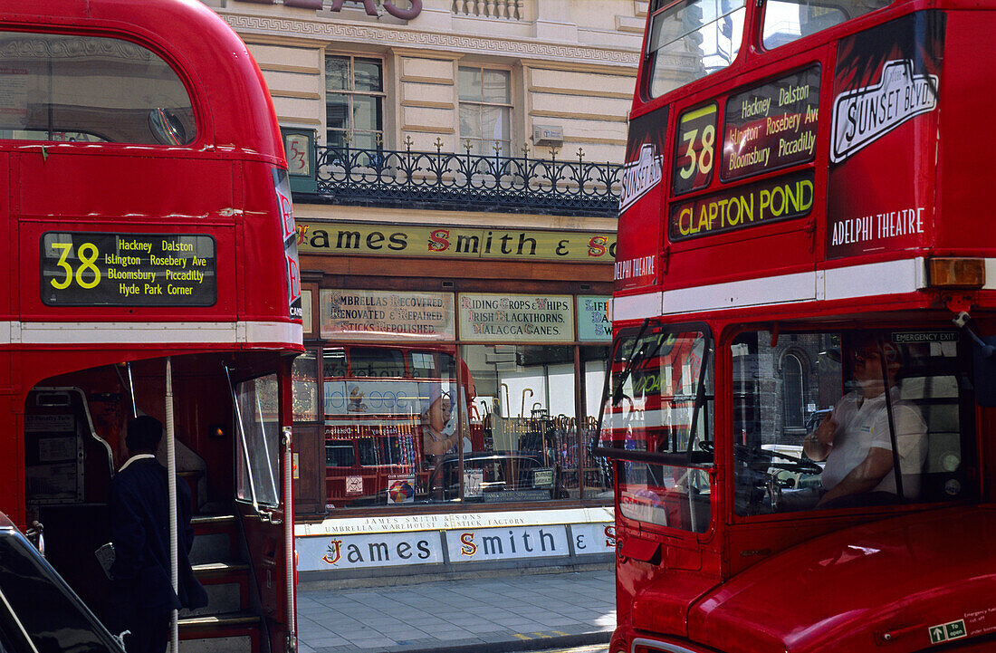 Europe, Great Britain, England, London, typical red busses on front of Hazelwood House on New Oxford Street