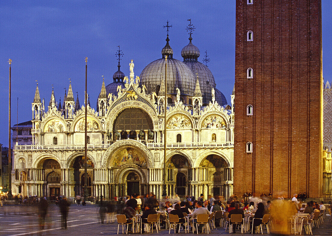 St. Mark's Square, People at Caffe Florian with St. Mark's basilica. Venice. Veneto, Italy