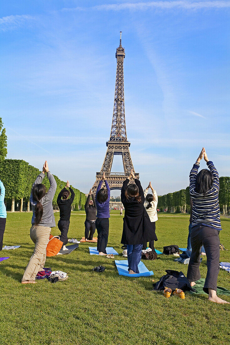 People doing Yoga, Eiffel Tower. Paris. France