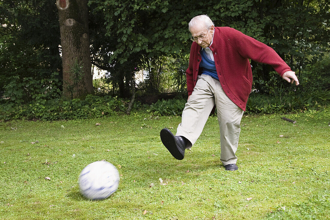 Senior man playing soccer, Bavaria, Germany